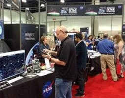 A man interacts with a display at a NASA booth