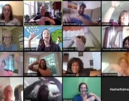 During a group webcam chat, teachers use their hands to dance.