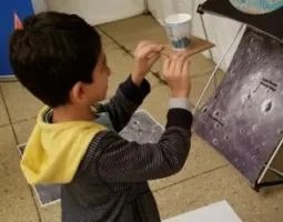 A young participant preparing to test out his lunar lander, aiming for the Moon's south pole.