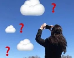 A woman holds a phone up to animated clouds.