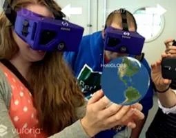 A woman wearing a VR headset holds the earth in her hands.