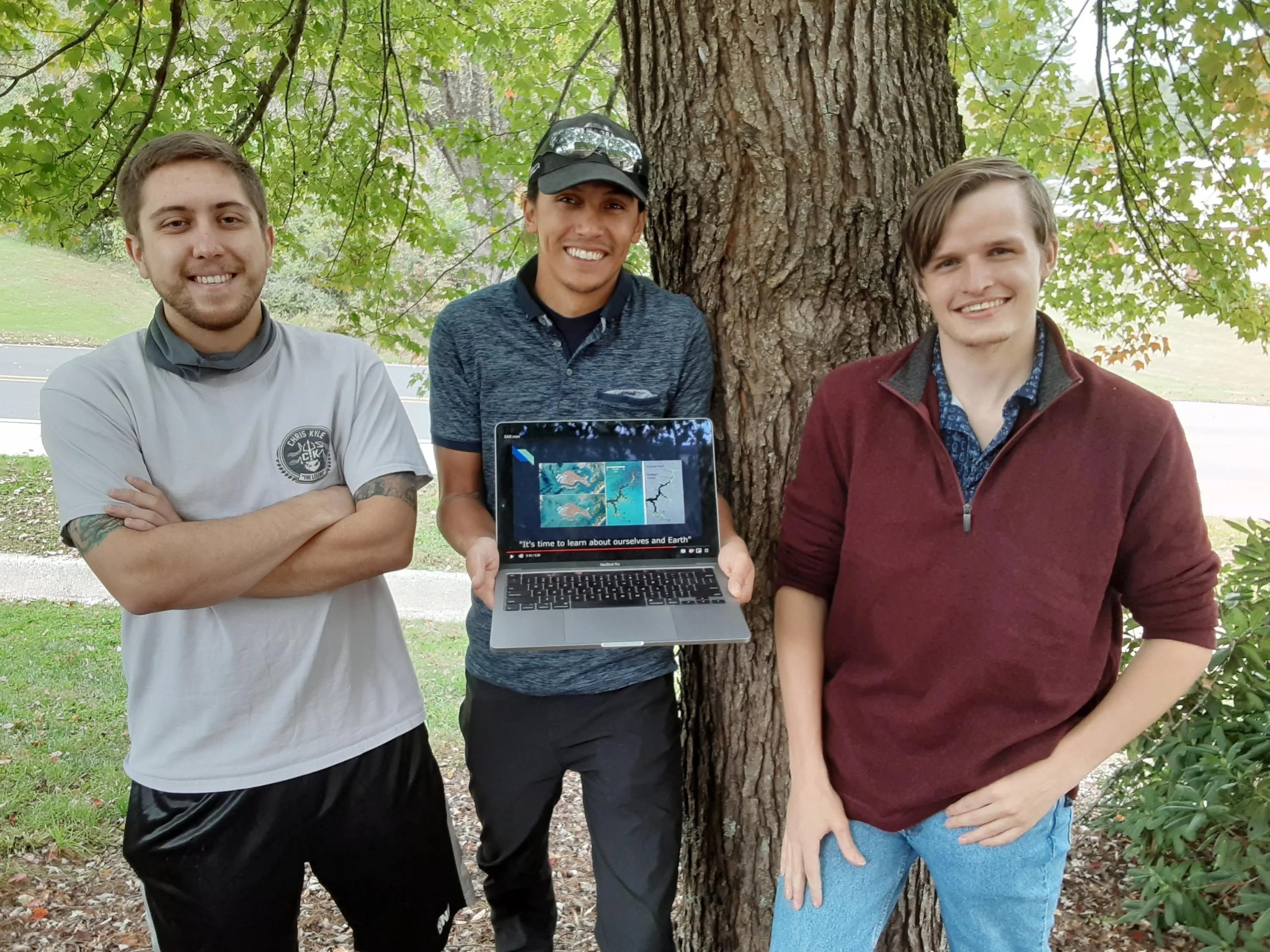 The three global nominees for the Rosman location for the 2021 Space Apps Challenge.  Andrew Frady, Alberto Cruz, and Daniel Triplett pose with their project outside of Southwestern Community College.