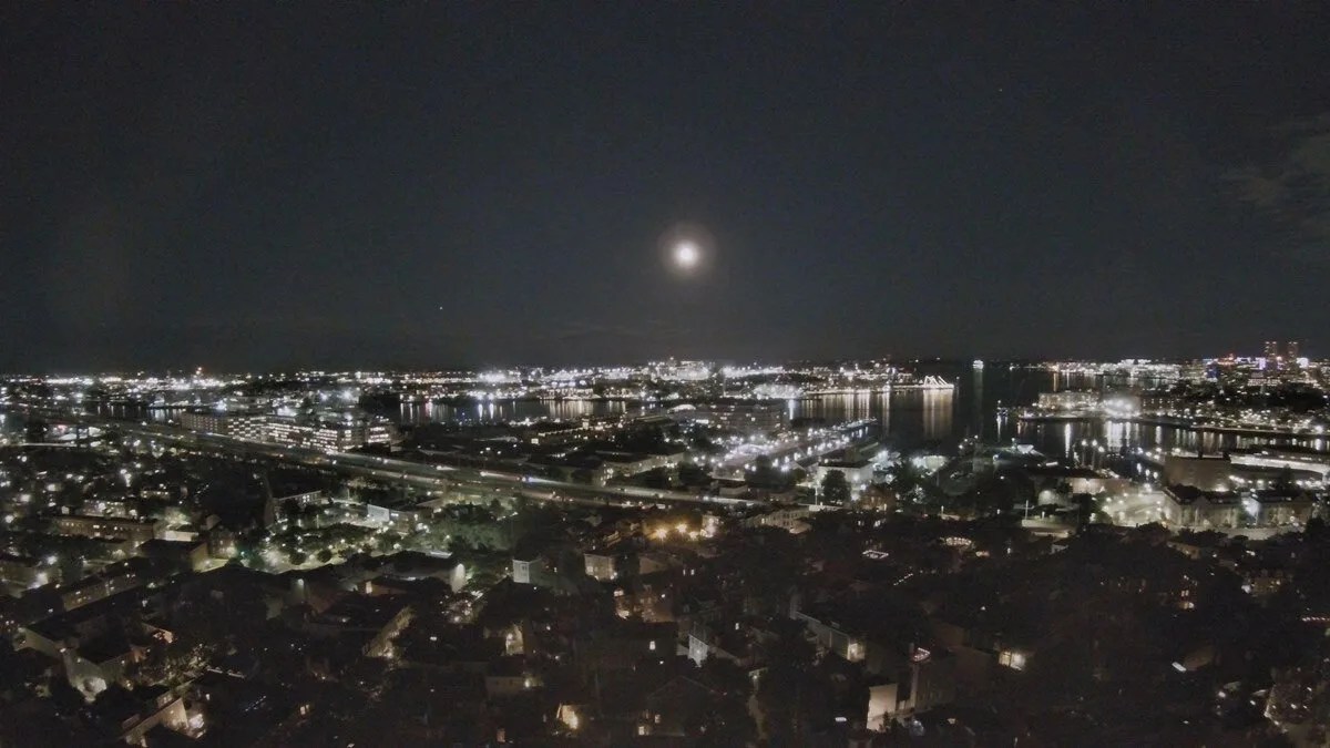 A full Moon hovers above Boston Harbor in this photograph taken from the top of the Bunker Hill monument.