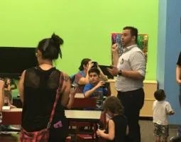 Dr. Edgard Rivera-Valentín speaking to children with VR headsets.