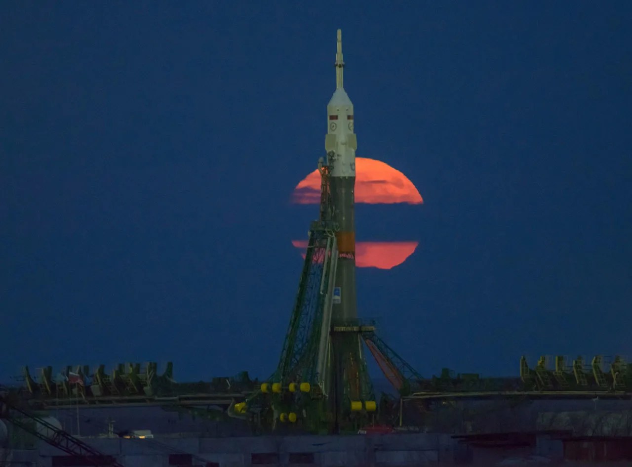 Full moon rising behind a Russian rocket on the launch pad.