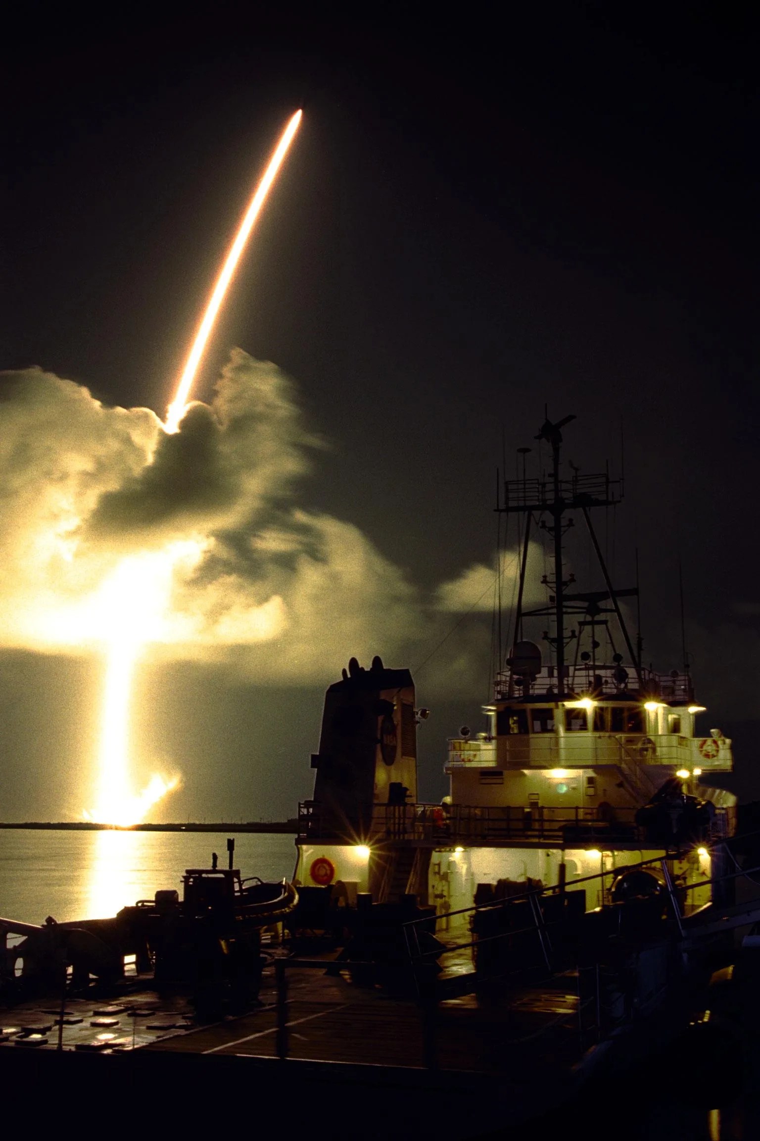 Timelapse image shows rocket streaking through a cloud.