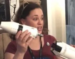 Kelly Christopher holds an Apollo 11 model.