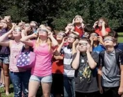 Students wearing eclipse glasses