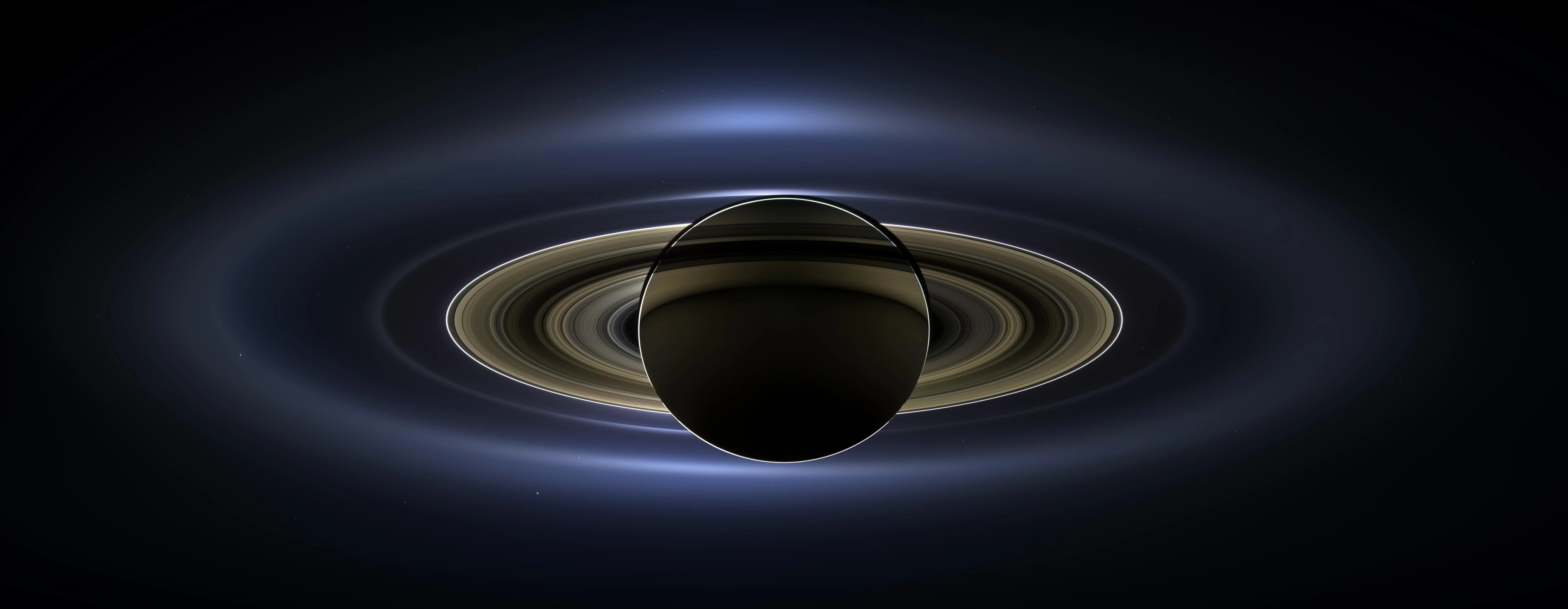 Color image of Saturn backlit by the sun.