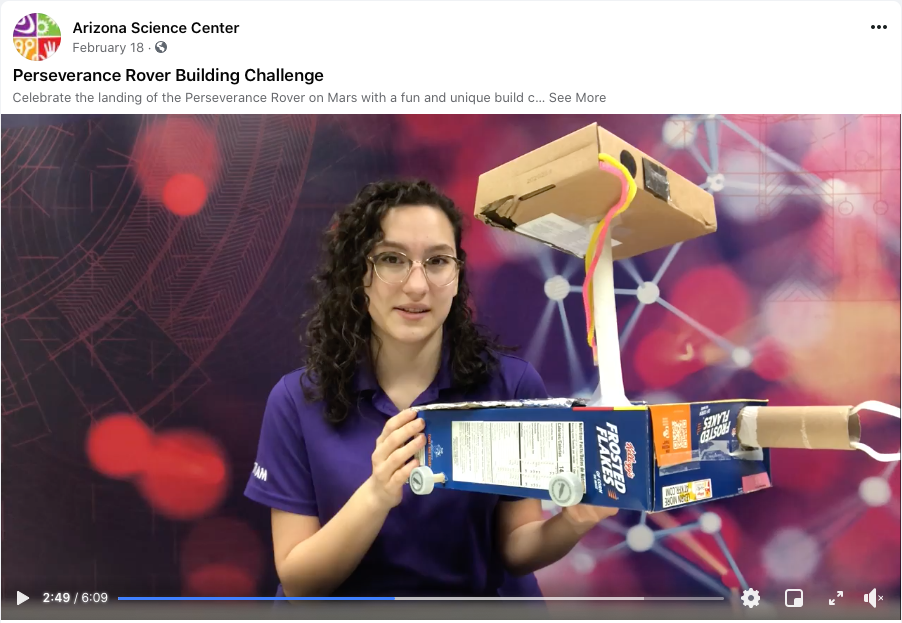 Video screenshot from the Arizona Science Center Perseverance Rover Building Challenge - the museum educator is holding a model of a rover built from everyday materials.