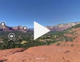 Video screenshot of the Sedona landforms with a large Play button.