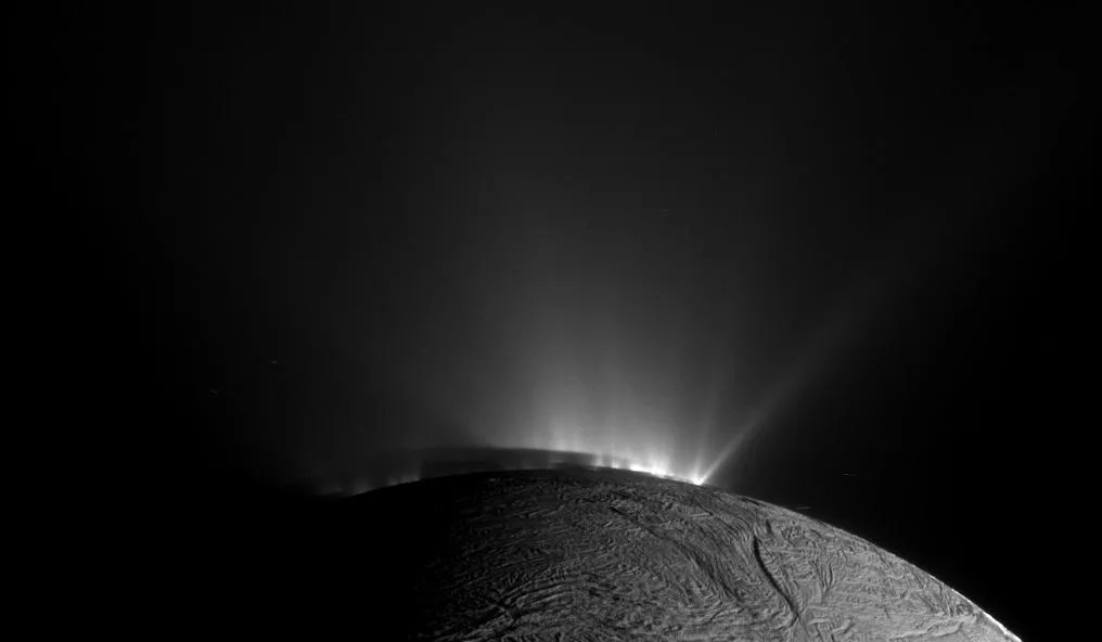 Backlit plume erupting from Enceladus