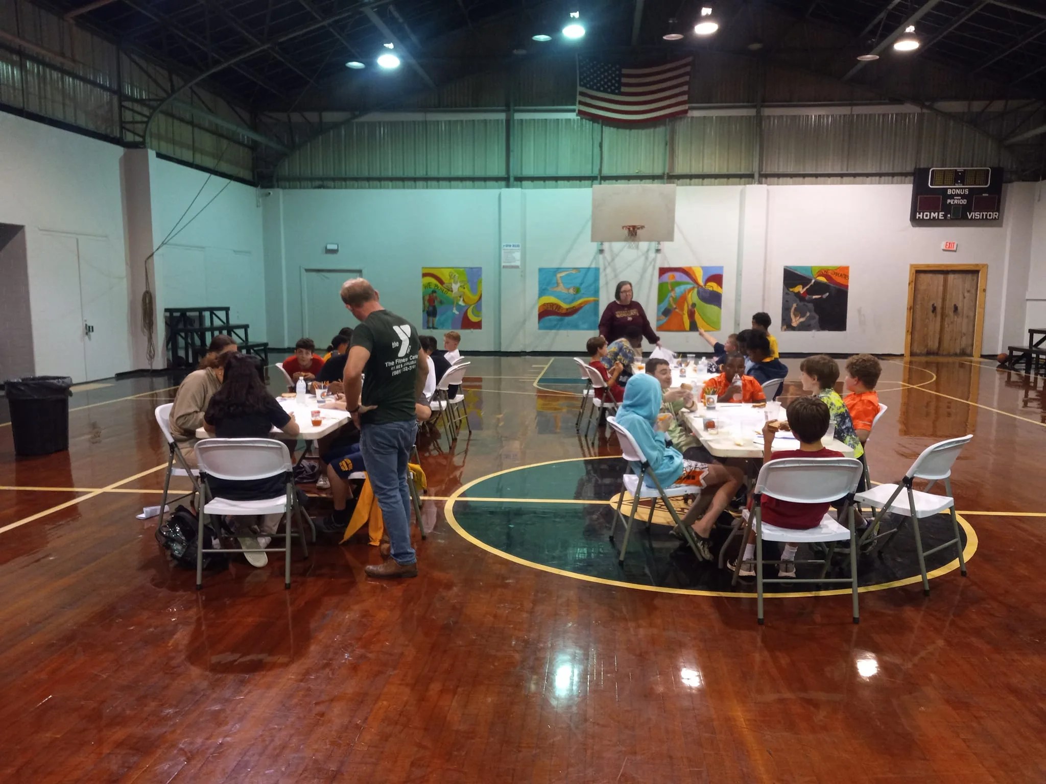 Bogalusa YMCA participants work on mission patches as George Corkern, the trained NASA partner, explains that each individual brings their own special skills to the team on Nov. 11in Louisiana. The brochure lists NASA and the Planetarium as major attractions in the Hammond Science EXPLO event.