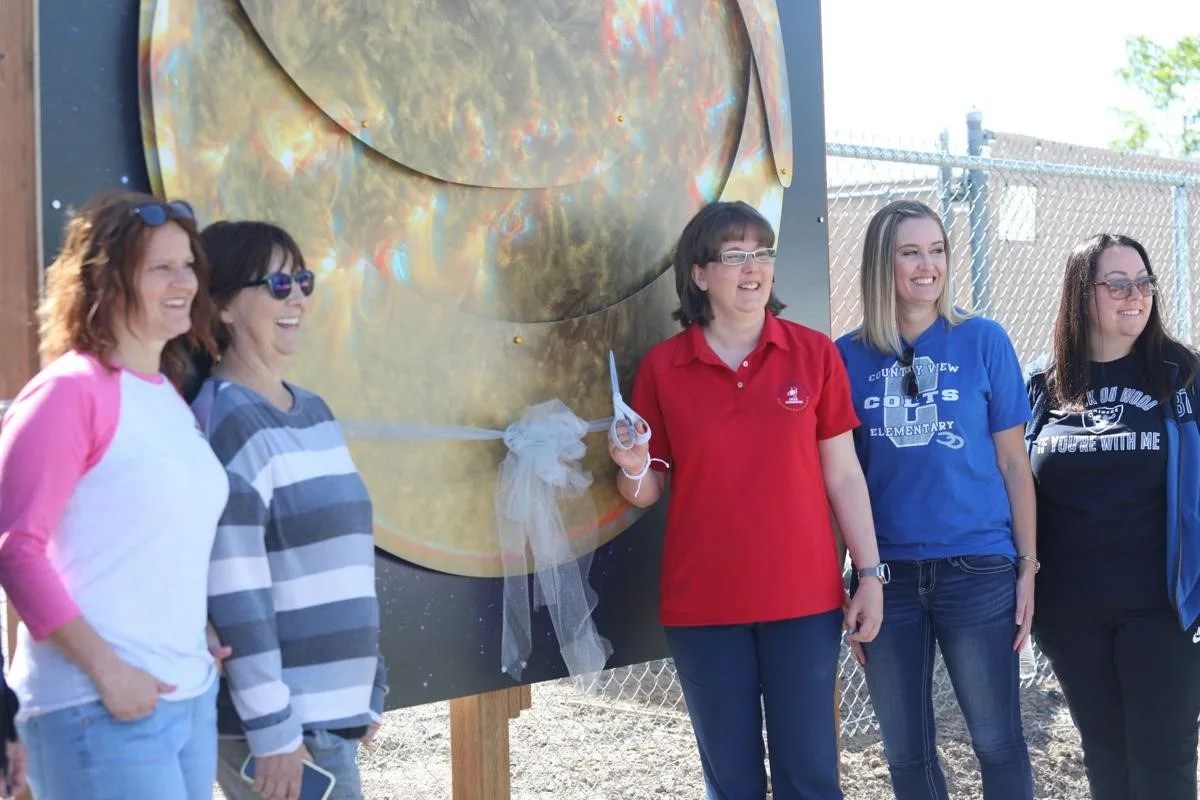 SSA Jennifer Jones, center, prepares to cut the ribbon at the grand opening of the Solar System Trail for Astronomical Research by Students.