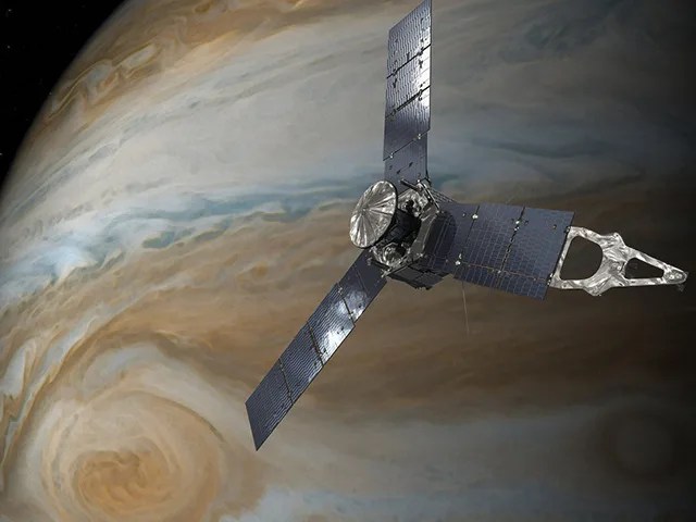 Illustration of the tri-winged spacecraft over the planet Jupiter, which is tan and white striped, with a streak of blue above the Great Red Spot, a swirling orange storm on Jupiter, at lower left