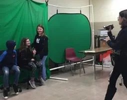 Kids creating Spotlite video in front of a green screen