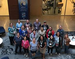 Group photo of AZGA summer institute participants. Photo taken from above and participants standing on carpeting with Mars crater images printed on it.