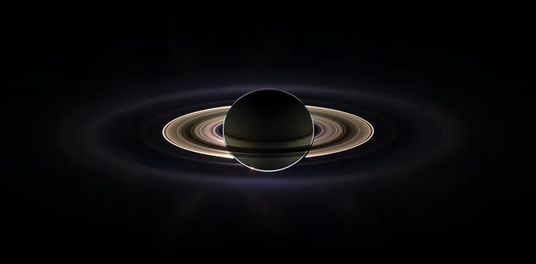 With giant Saturn hanging in the blackness and sheltering Cassini from the sun's blinding glare, the spacecraft viewed the rings as never before, on Sept. 15, 2006.