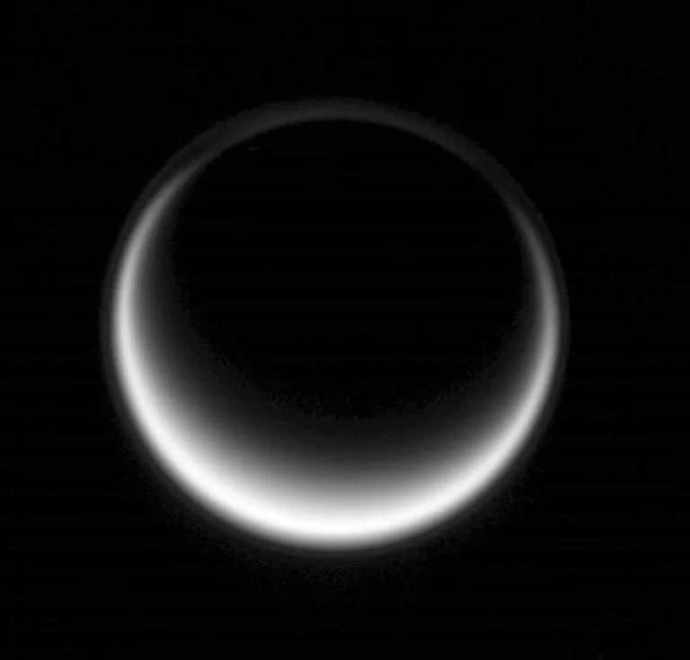 Sunlight scatters through Titan's atmosphere, illuminating high hazes and bathing the entire moon in a soft glow. Image taken May 12, 2007.