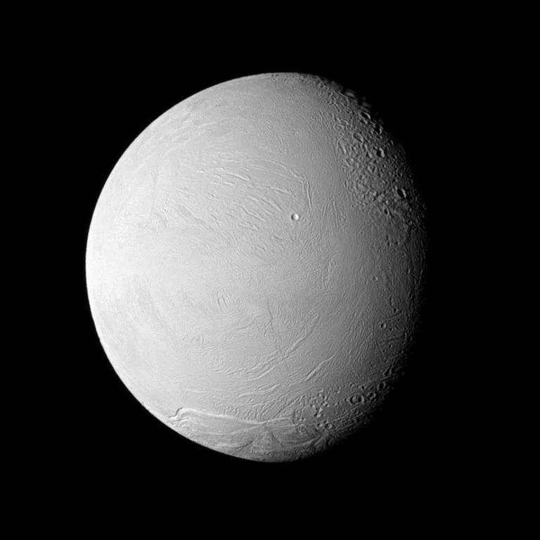 The Cassini spacecraft examines old and new terrain on Saturn's fascinating Enceladus, a moon where jets of water ice particles and vapor spew from the south pole. This image was captured during Cassini's Nov. 21, 2009, flyby of the moon