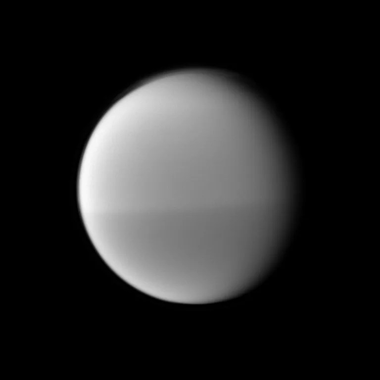 The Cassini spacecraft examines Titan's dark and light seasonal hemispheric dichotomy as it images the moon with a filter sensitive to near-infrared light. This image was taken May 22,2010.