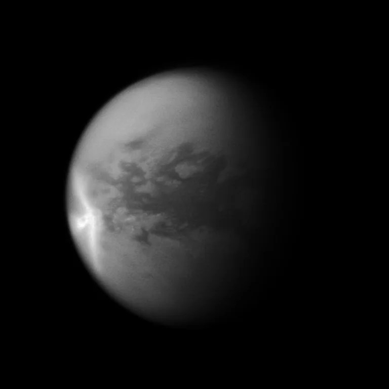 A huge arrow-shaped storm blows across the equatorial region of Titan in this image from NASA's Cassini spacecraft, chronicling the seasonal weather changes on Saturn's largest moon. This image is a mosaic of two Cassini images. Most of this view is from an image of the storm captured on Sept. 27, 2010. However, because that image's framing cut off the south polar region of the moon, a second image taken on July 9, 2010, was used to fill in that portion of the moon.