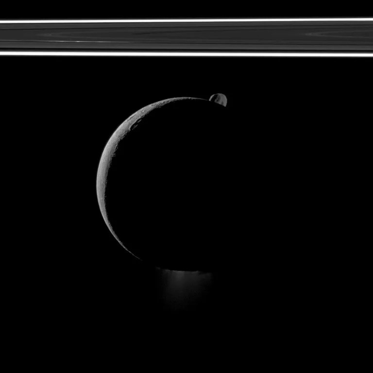 During a flyby of Saturn's moon Enceladus on Oct. 1, 2011, the Cassini spacecraft snapped this portrait of the moon joined by its sibling Epimetheus and the planet's rings.