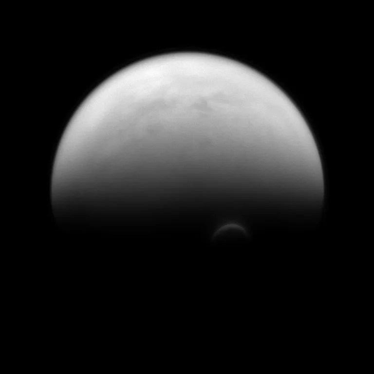 The sunlit edge of Titan's south polar vortex stands out distinctly against the darkness of the moon’s unilluminated hazy atmosphere. The Cassini spacecraft images of the vortex led scientists to conclude that its clouds form at a much higher altitude - where sunlight can still reach - than the surrounding haze. Image released Dec. 2, 2013.