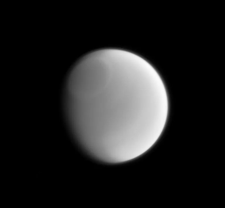 Only a sharp and careful eye can make out the subtle variations in Titan's clouds when viewed in visible light. However, these subtle features sometimes become more readily apparent when imaged at other wavelengths of light. This infrared image clearly reveals a band around the Titan's north pole. Image released June 23, 2014.