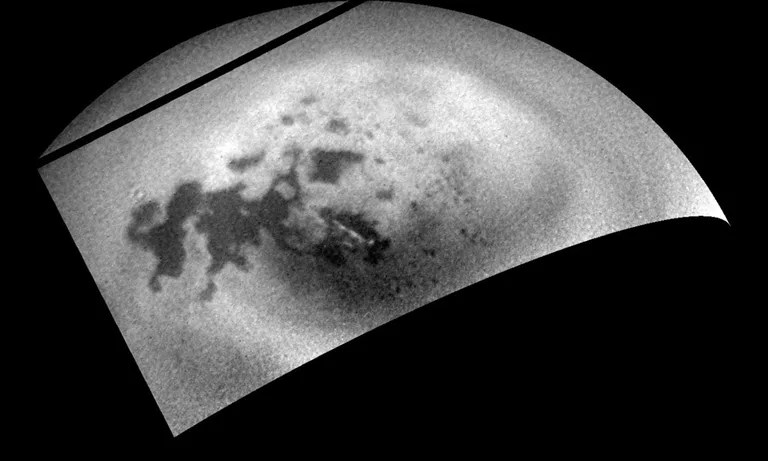 As the Cassini spacecraft sped away from Titan following a relatively close flyby, its cameras monitored the moon's northern polar region, capturing signs of renewed cloud activity. Image released Aug. 12, 2014