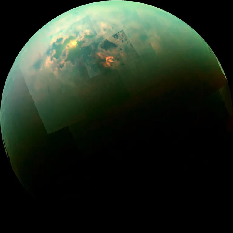 See the sun glinting off of Titan's north polar seas in this near-infrared, color mosaic from NASA's Cassini spacecraft. The mirror-like reflection is in the south of Titan's largest sea, Kraken mare. This view was acquired on Aug. 21, 2014.