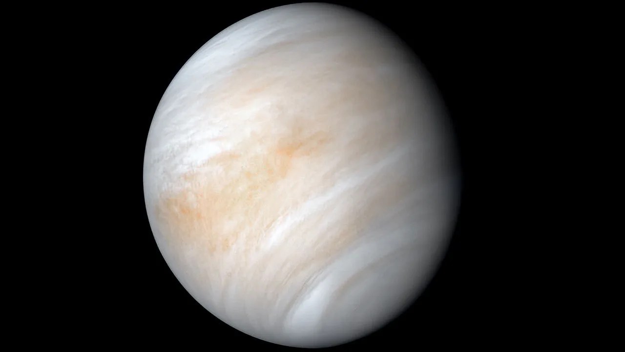 Enhanced view of Venus with image processing to reveal variations in the brownish clouds that cover the planet.