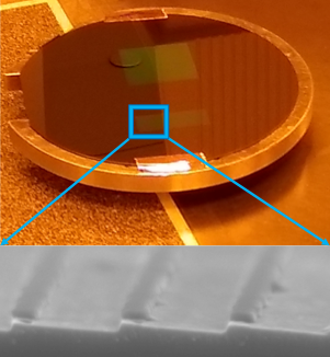 A PSU test wafer with a scanning electron microscope (SEM) image of a 3.6 degree blaze angle (below). The residual nitride layer at the top of each groove has not been removed for this test piece. The groove facets are extremely smooth and the shallow blaze is well defined.