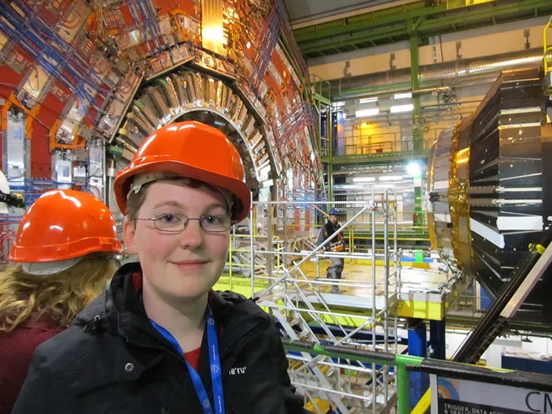 Young woman in hardhat underground at the CERN complex in Europe.