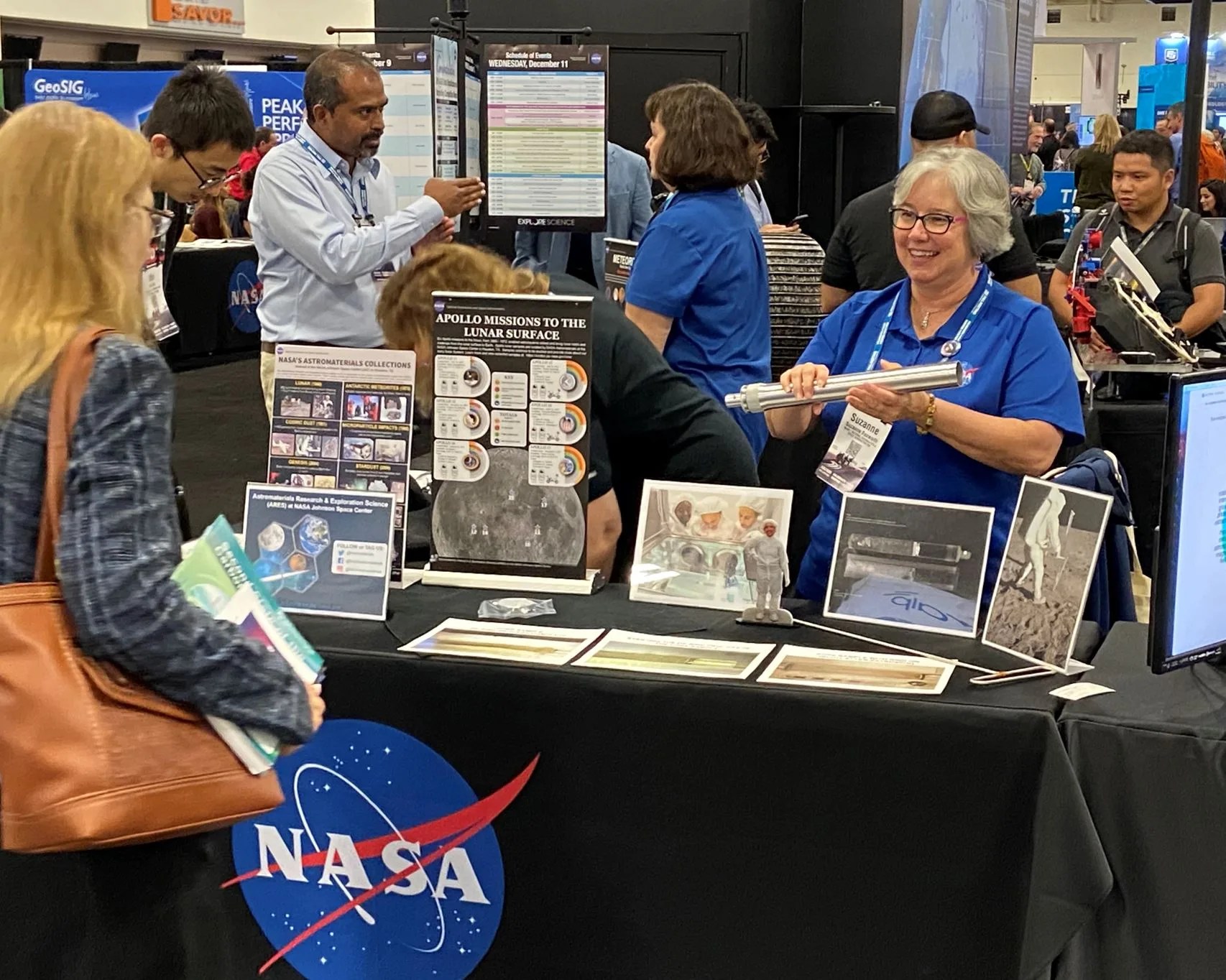 An ARES team member displays a replica of the ANGSA core tube at the NASA booth. The December 2019 AGU Meeting took place at the Moscone Center in San Francisco.