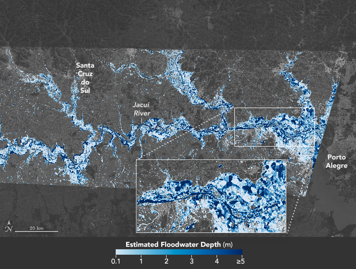 Satellite image shown in false color. the land and broader sea are grayscale, with the Jacuí and surrounding floodplains shown in a scale of blue from near white to a navy blue, the darker the color the deeper the water in meters. The River runs left to right with a few contributing tributaries coming down to the river from the top of the image and at their center runs a dark blue channel that are the ordinary banks for the river, however, near the mouth there is a zoomed in section of the image showing how expansive and deep sections of the flooding have become.