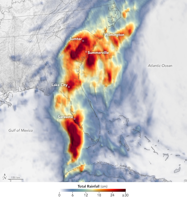 Rainfall measurements are assigned color from white, indicating no rain, to blue and red. The darkest red would be 30 centimeters of rain. This scale is superimposed over a color free map of the Southeast United States and shows the Gulf Coast of Florida in a deep shade of red, the shade intensity lessens as it stretches inland, however, the color darkens as it heads into coastal South Carolina. The remainder of pictured East Coast shows blue to light yellow coded amounts of rainfall.