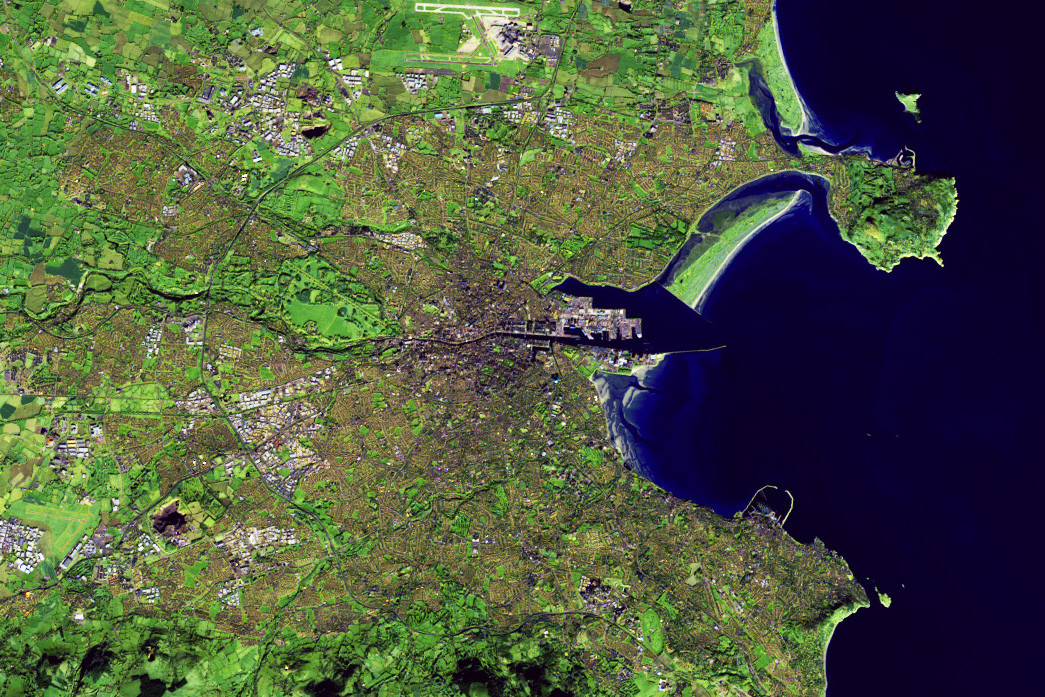 The image shows the extent to which urban areas have grown. The image was acquired by Landsat 8, and is false color to emphasize the difference between vegetated (green) and built-up areas (gray and brown). Dublin’s growth has been fairly low-density, and some greenness remains even in urban areas.