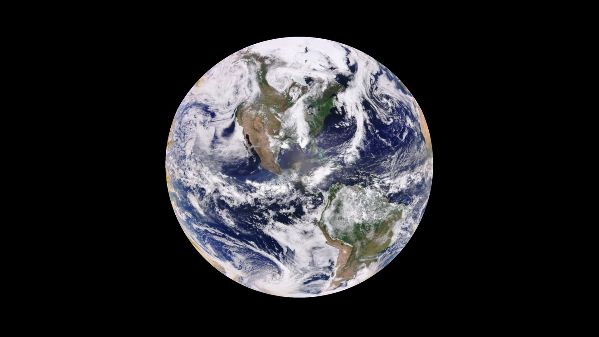 A view of Earth from a satellite. The planet has lots of clouds on this date. The blue of the ocean also can be seen.