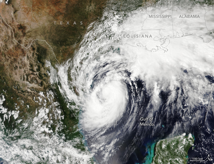 Swirling white clouds appear centered over the Gulf of Mexico. The outer bands cover the U.S. Gulf Coast, though only the panhandle of Florida is pictured.