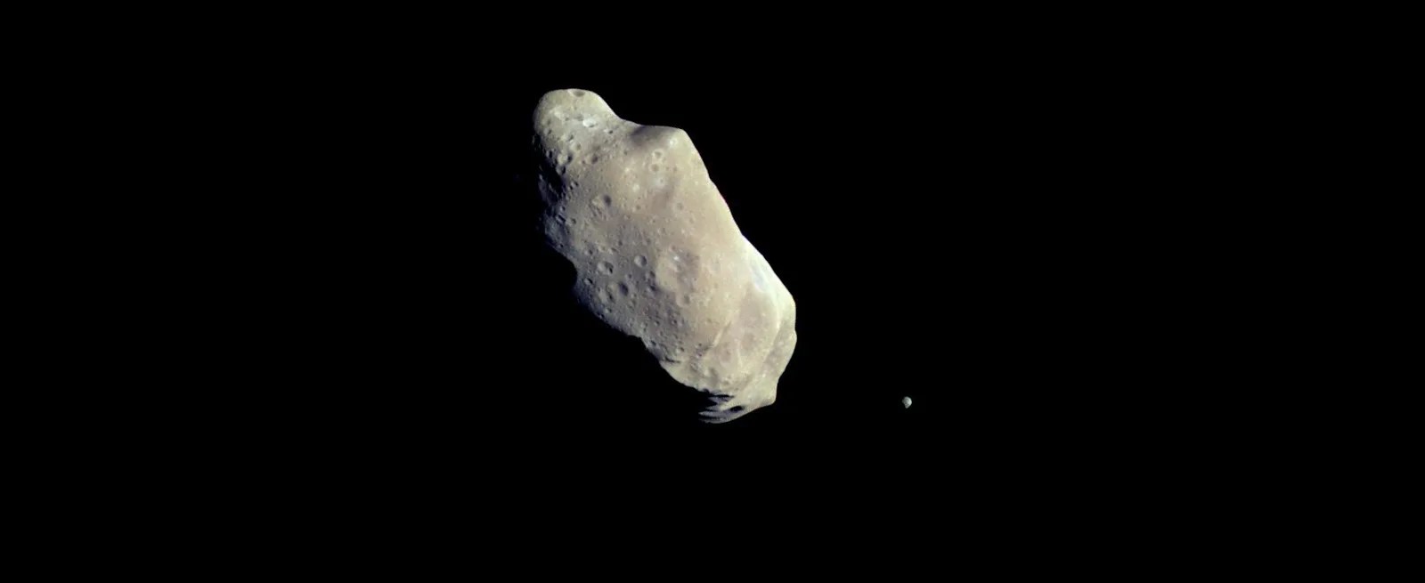 two rocky asteroids in black space