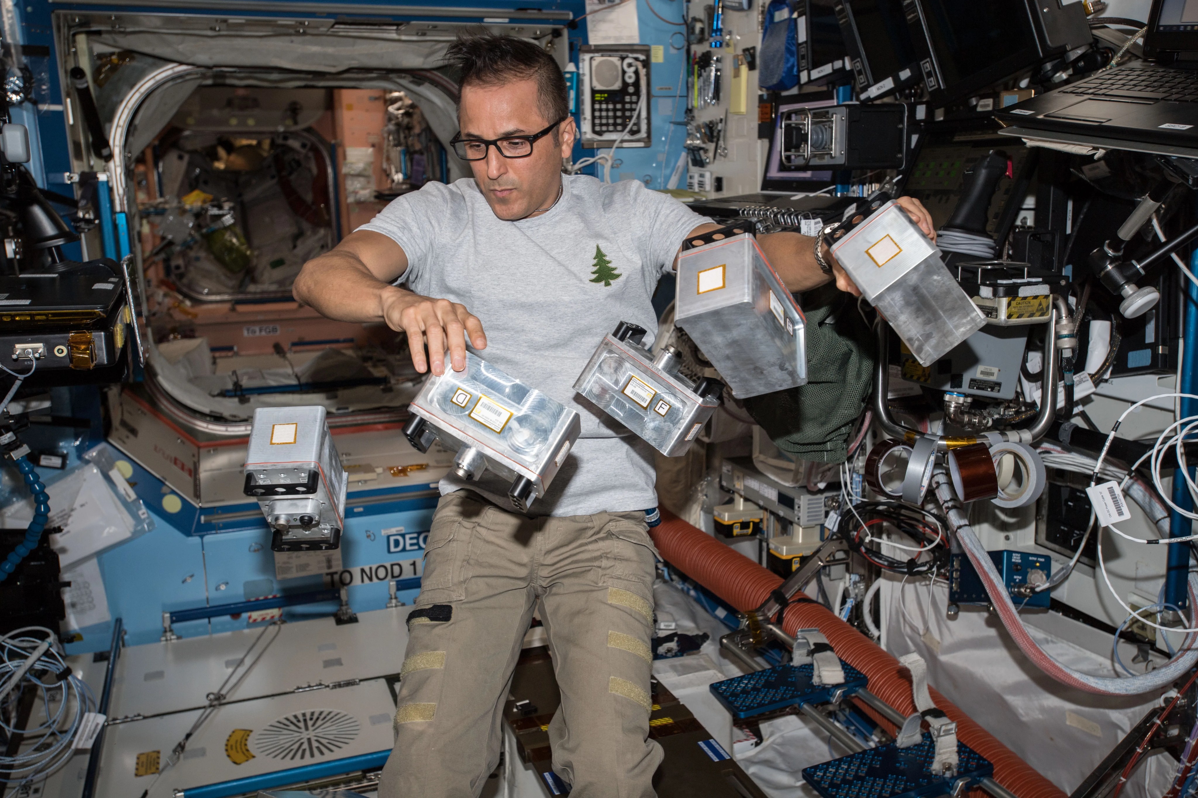 NASA Image: ISS054E001485 - NASA astronaut Joe Acaba with Biological Research in Canisters - Light Emitting Diode (BRIC-LED) canisters prior to installation in the Destiny Laboratory to provide capabilities for seedling, microbial, or fungal growth investigations.