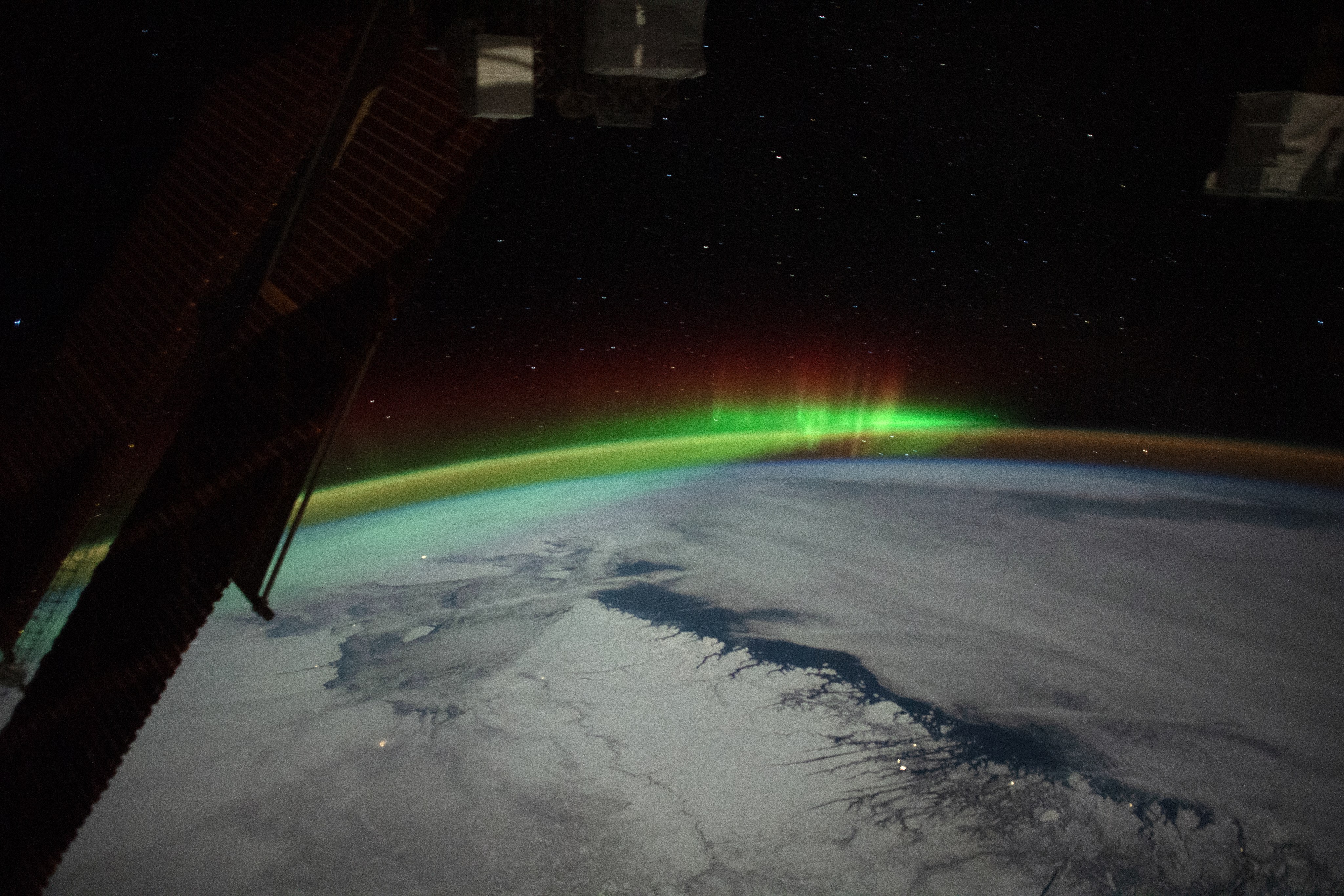 An astronaut aboard the International Space Station took this photo of eastern Canada. The image was taken near the northernmost limit of the station’s inclined equatorial orbit, which tops out about 52 degrees north of the equator. The perspective includes a view of space station’s solar panels in the foreground, Earth’s horizon about 1,500 kilometers (930 miles) away, and celestial objects far in the distance. Lights, snow, and clouds brighten the winter scene on Earth.
