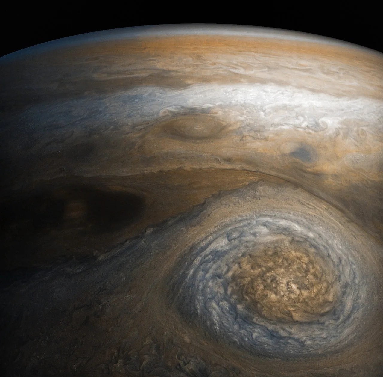 A dynamic storm at the southern edge of Jupiter’s northern polar region dominates this Jovian cloudscape.