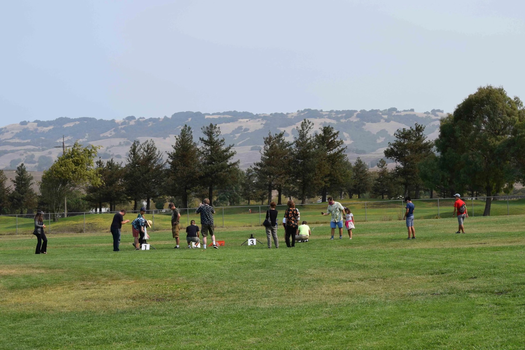 Rocketeers gather near each of the four launch pads to wire up their rockets to igniters.