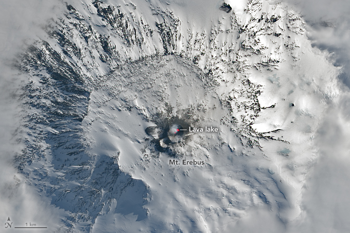 The fiery and icy upper reaches of the Antarctic volcano pierced through a canopy of clouds.