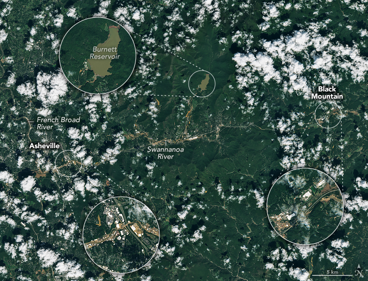 Amid sporadic cloud coverage there are three locations visible and zoomed in on with a pop-out bubble. They are Asheville, center left, shown with a brown swath interrupting the city streets. In the upper center the Burnett Reservoir shows the waters being a very murky brown. Black Mountain, center right, shows similar brown soil covers human settlement areas.