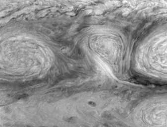 This animated GIF shows three giant storms swirling in a neat row on Jupiter.
