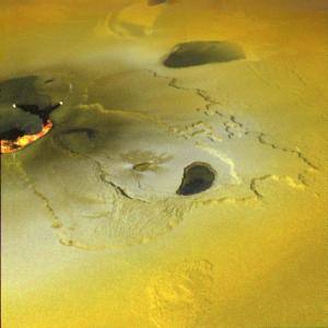 Glowing lava fills a crevice in this close up view of the surface of volcanic Io.