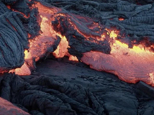 Flowing lava, alternating in color between black and bright yellow and orange.
